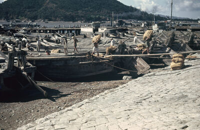 Boats and people, carrying sacks