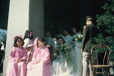 A bride on Western style wedding dress & two kids on Korean traditional pink dress